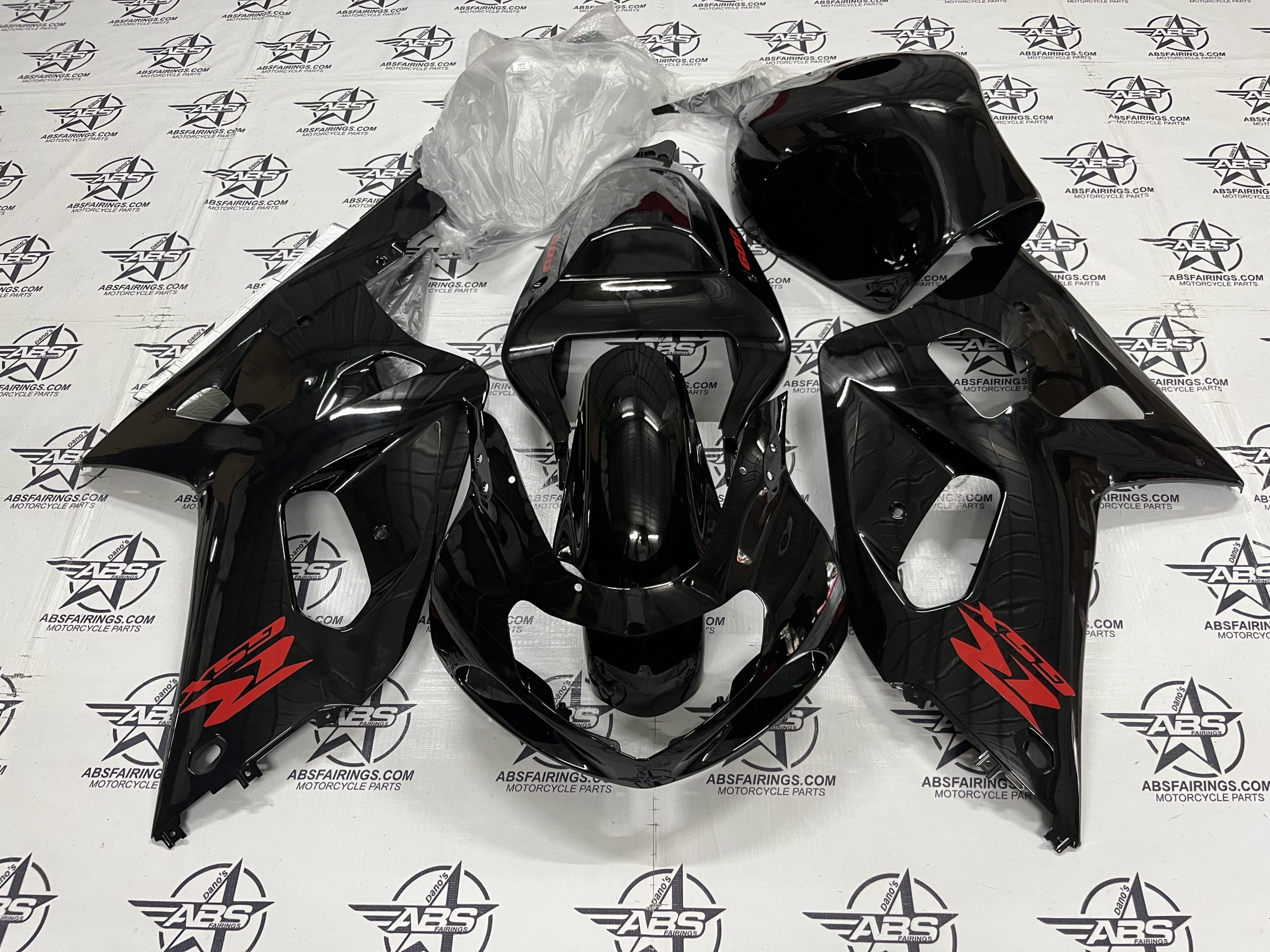 Black motorcycle fairings on ABS Fairings backdrop.