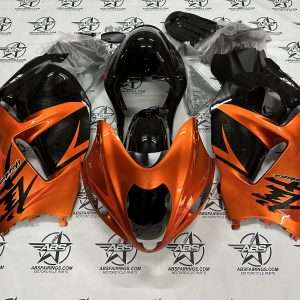 Orange motorcycle fairing set on branded background.