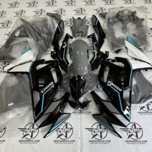 Motorcycle fairing kit pieces arranged, black and white design.