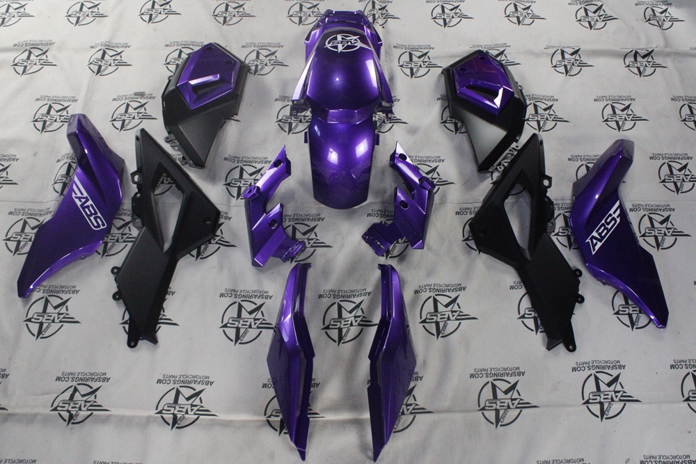 Purple motorcycle fairing kit laid out on display.