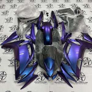 Purple motorcycle fairings kit on branded backdrop.