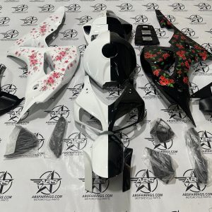 Motorcycle fairings with floral designs displayed.