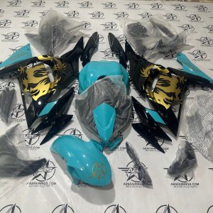 Motorcycle fairings laid out on branded backdrop.