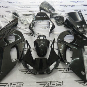 Black motorcycle fairing kit on ABS Moto mat.