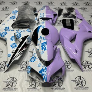 Purple and white motorcycle fairings with blue flowers.