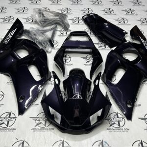 Motorcycle fairings in black arranged on floor.