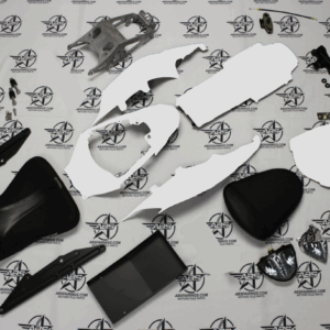 Motorcycle parts laid out on branded background.