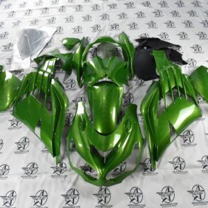 Green motorcycle fairings set laid out.