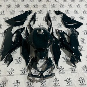 Motorcycle fairings displayed on branded fabric.
