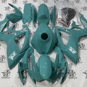 Turquoise motorcycle fairings set on a logo background.