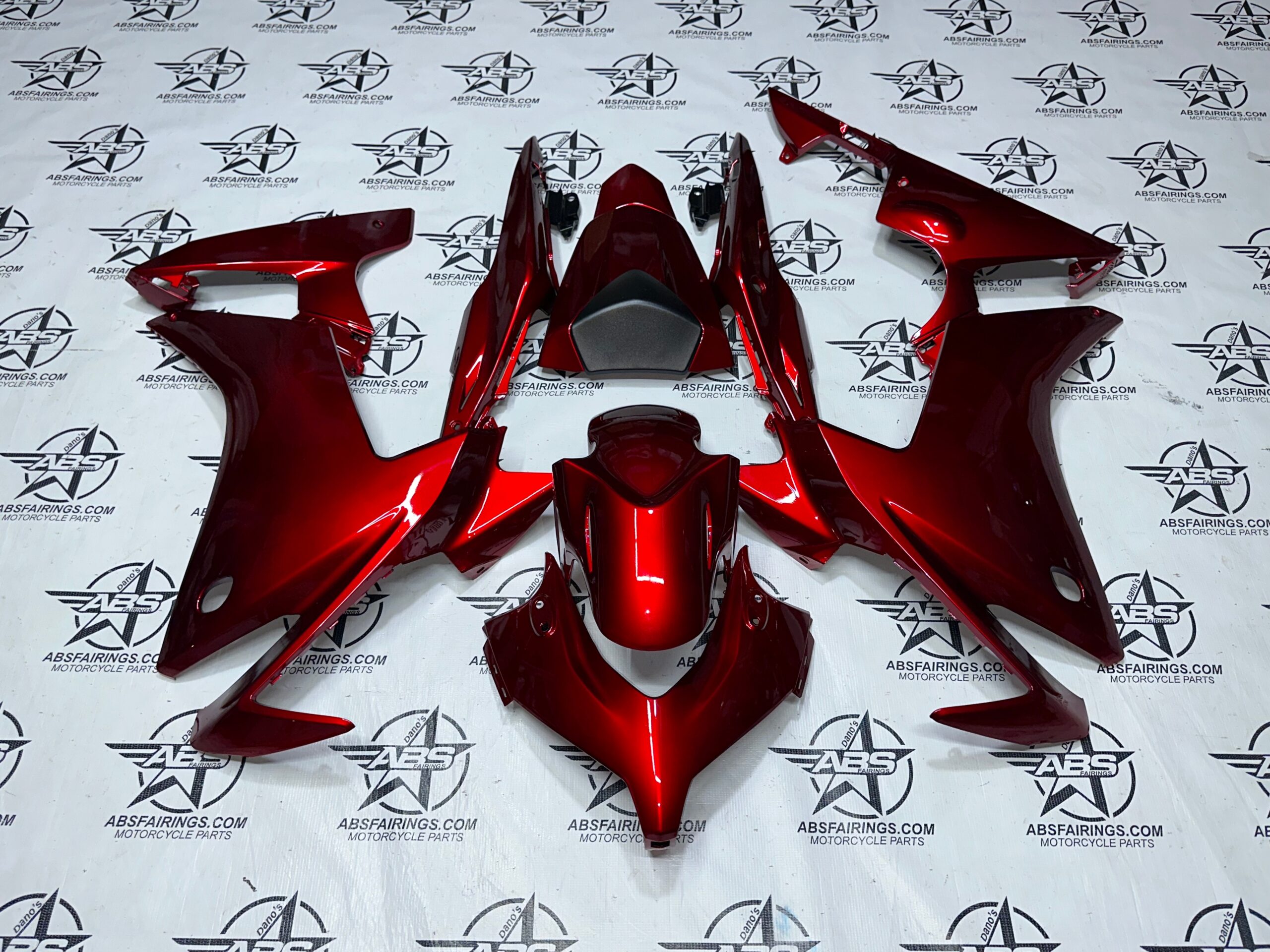 Red motorcycle fairings on display.