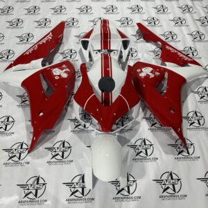 Red and white motorcycle fairing parts on display