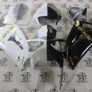 Motorcycle fairing kit in black and white colors.